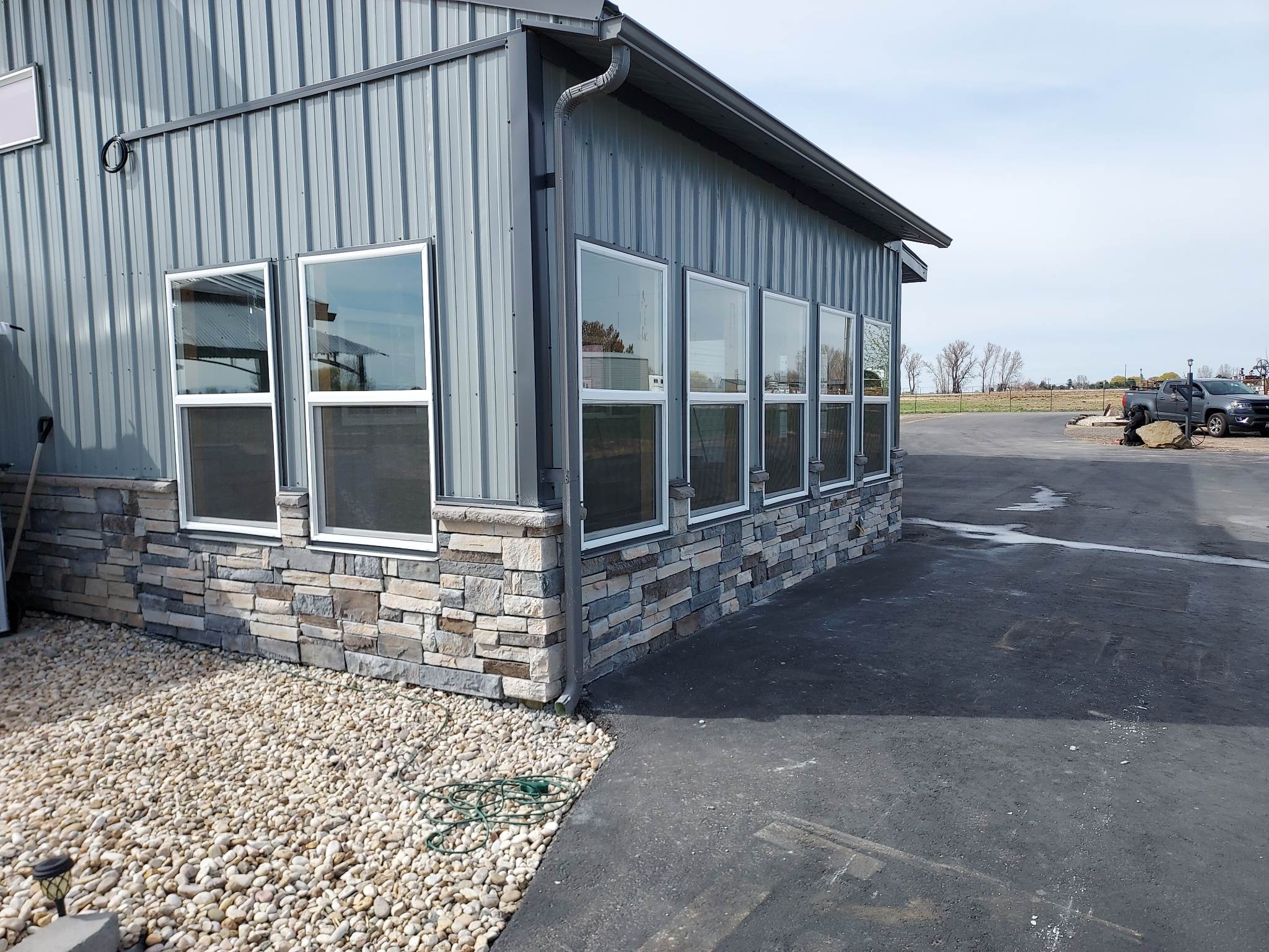 Warehouse with new siding and stone wall
