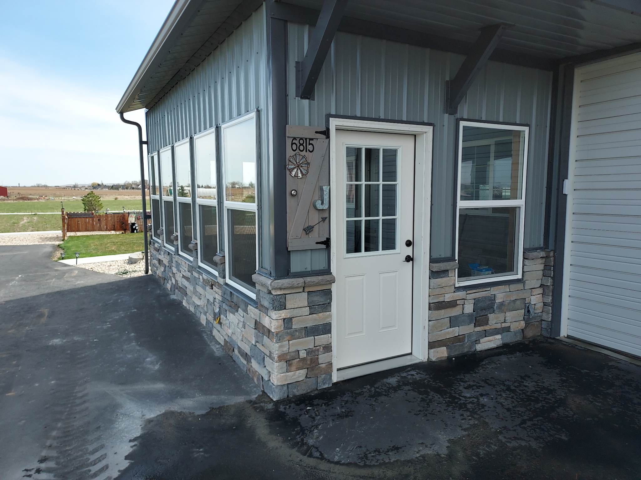 Another view of warehouse with new siding and patio overhang