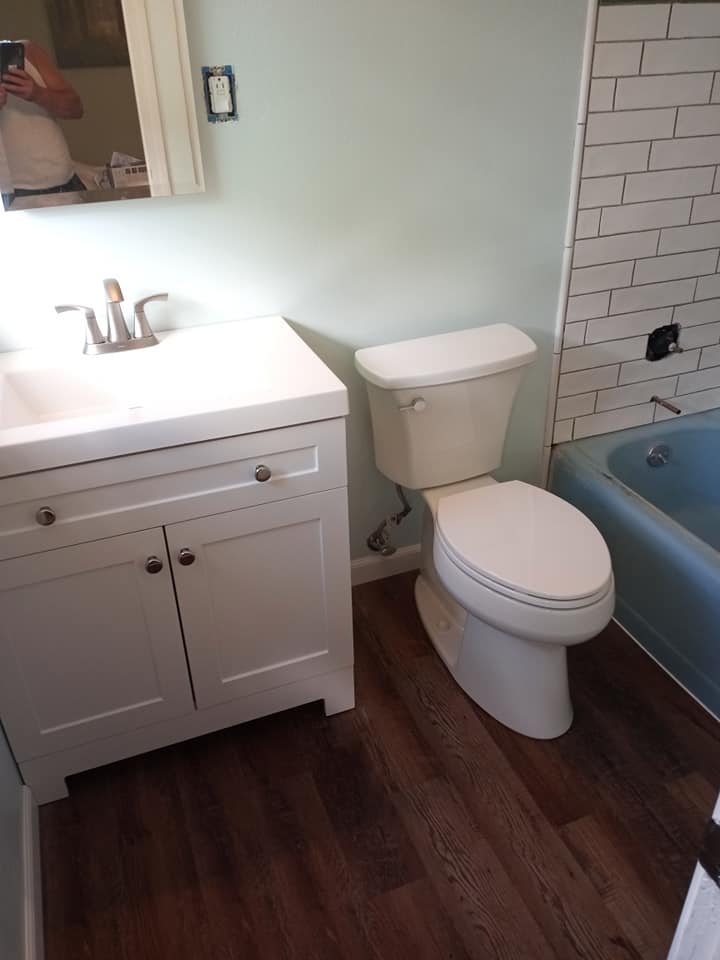 Bathroom after remodel with new floor, vanity and toilet