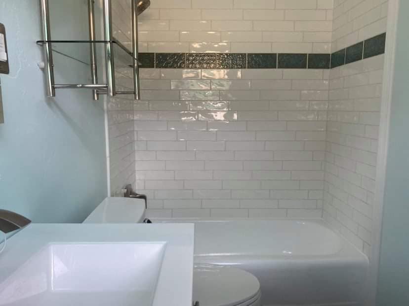 Bathroom shower with brand white new tile installed