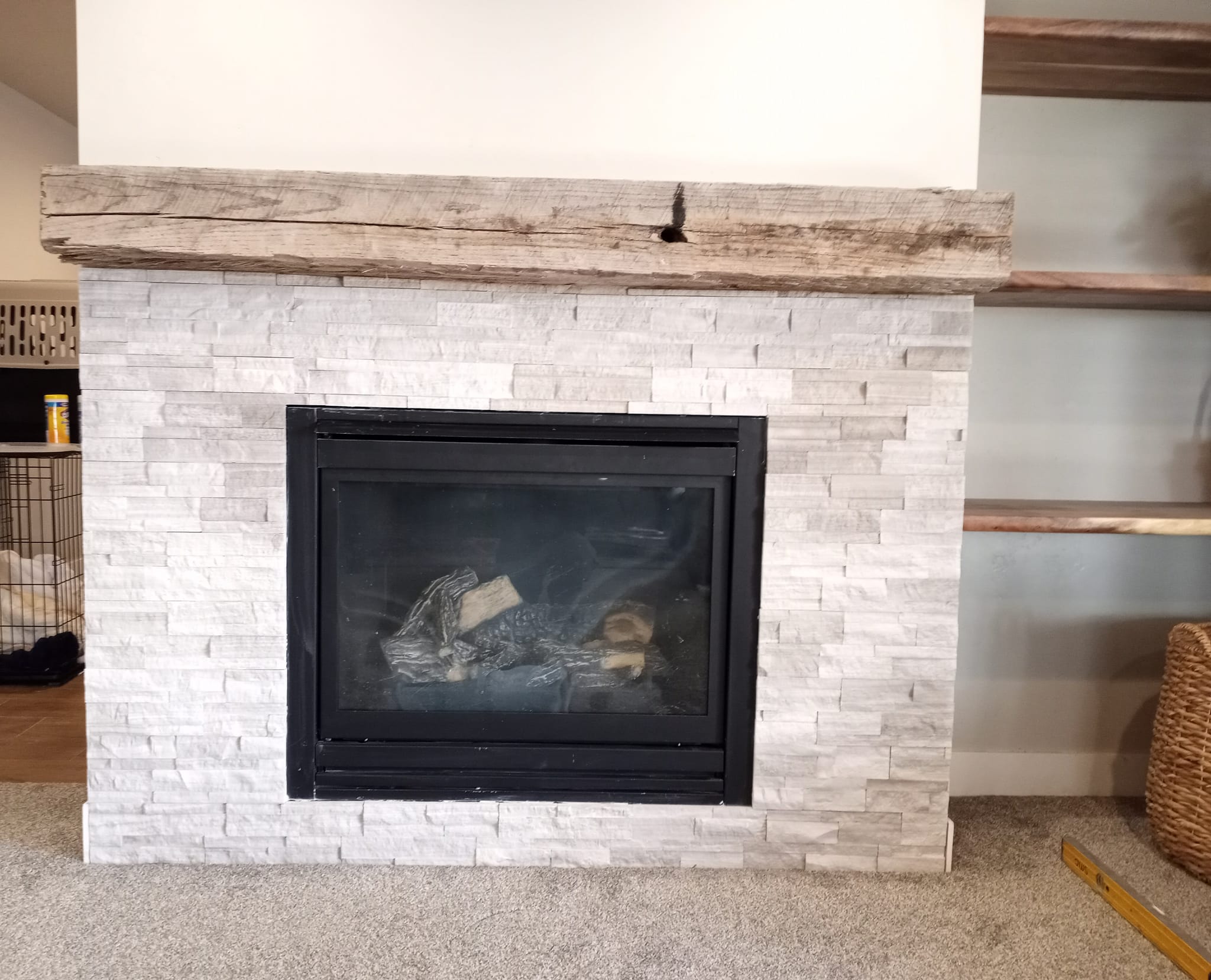 Light brick fireplace with old wood mantle