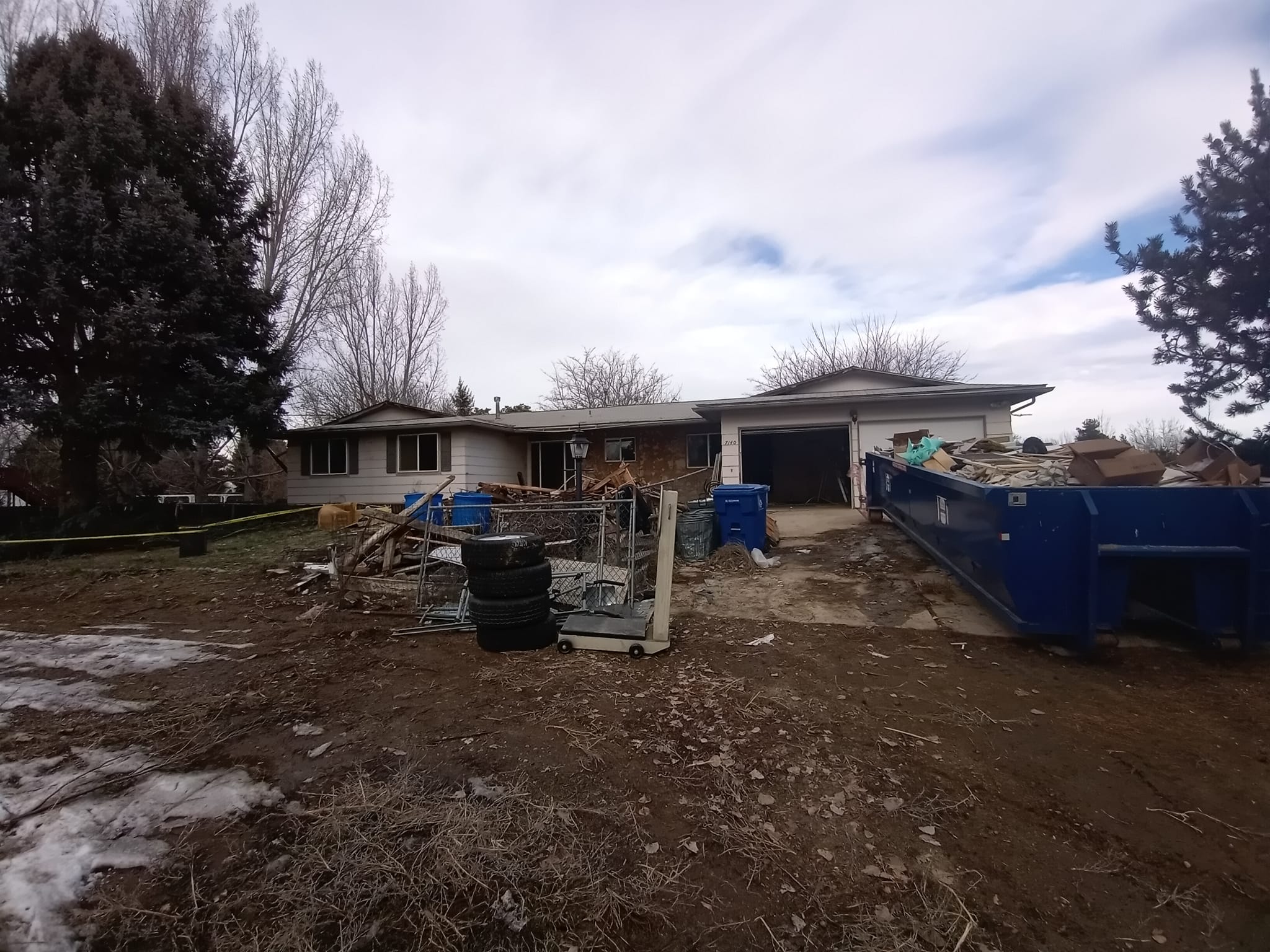 Messy house with trash all over the yard