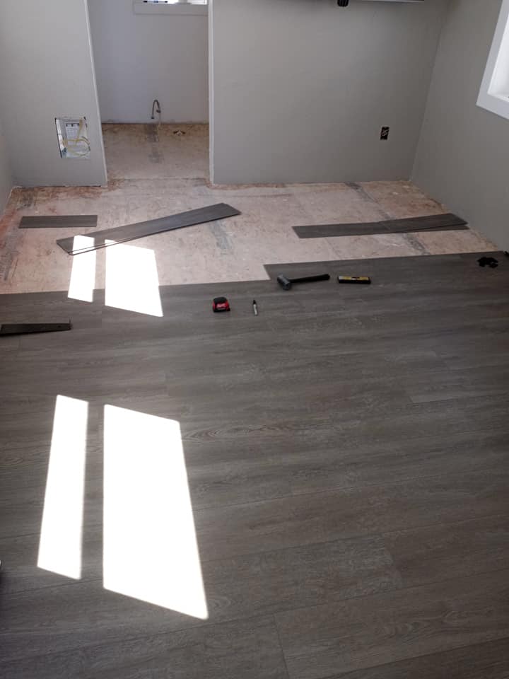 Progress of vinyl flooring being installed