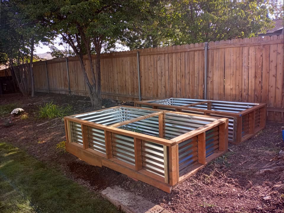 Four large square planters outside