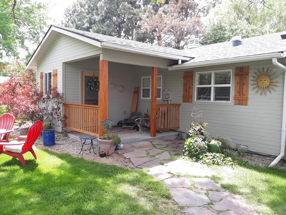 White house with brown railing for the patio