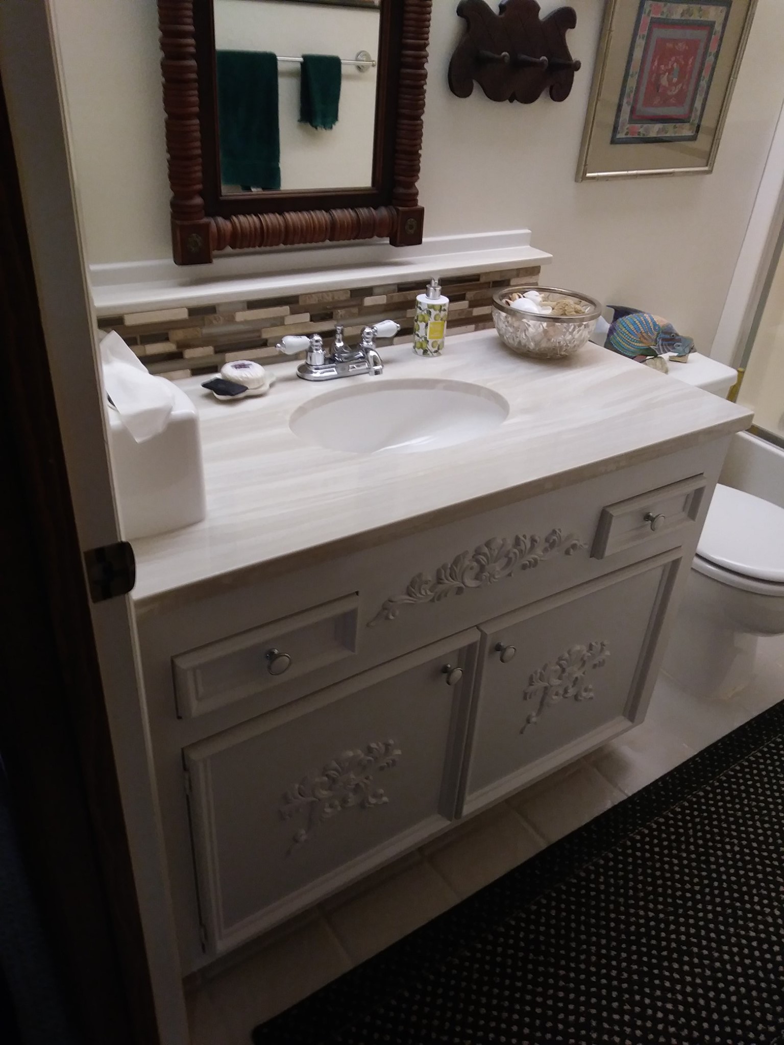 Bathroom vanity with new backsplash and detailed cabinets