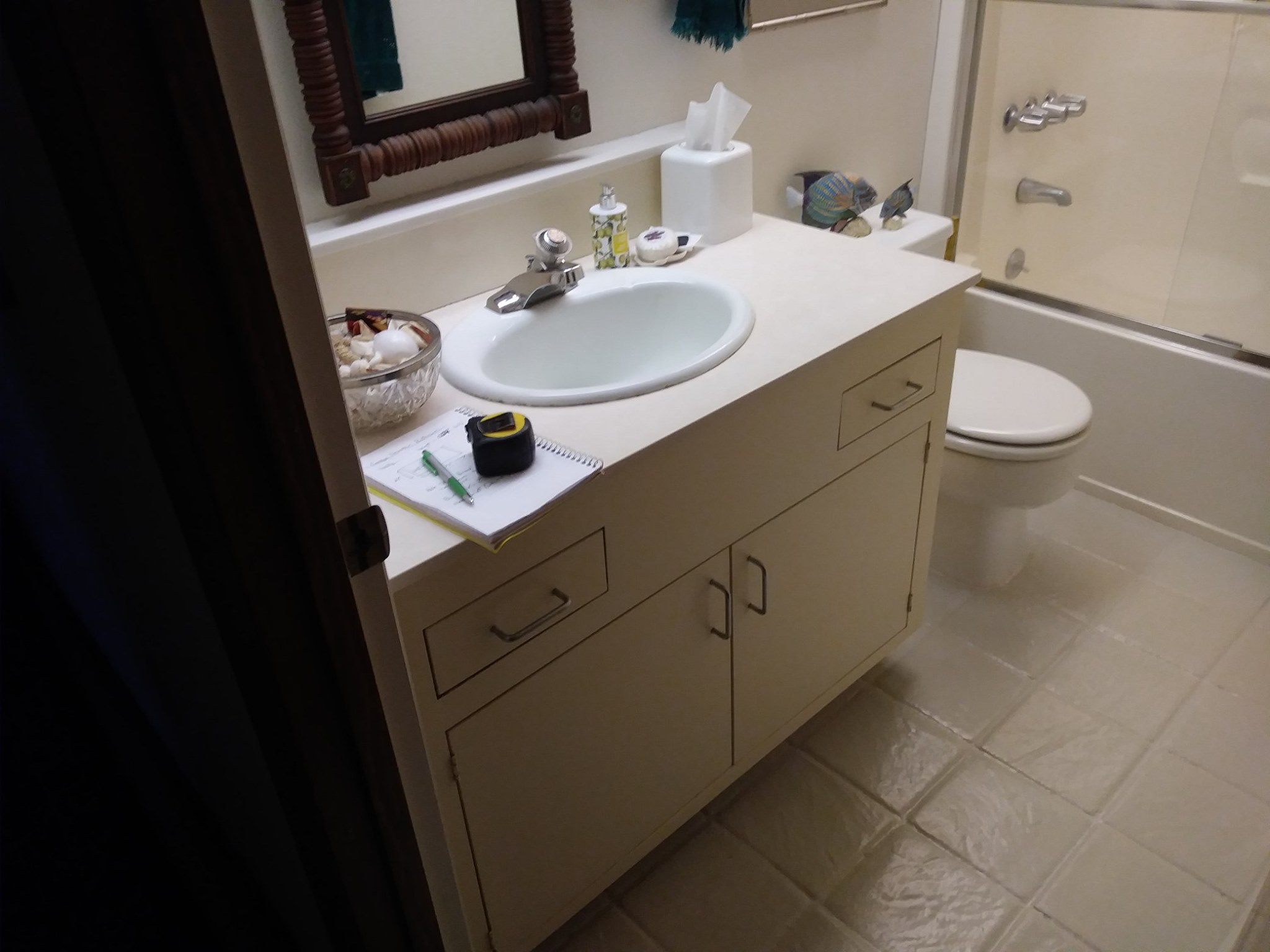 Bathroom with old white vanity before remodel
