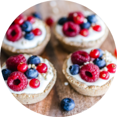 Small desserts with raspberries and blueberries on top
