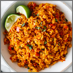 A large bowl of mexican rice with lime slices